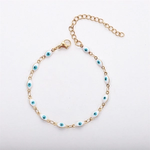 Detailed shot of 18K gold-plated Evil Eye chain with white enamel beads and lobster clasp