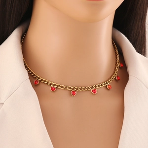 Golden Cuban chain necklace with seven red heart pendants worn by a professional model