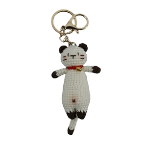 Handmade crochet white cat keychain with brown details, red collar and golden bell