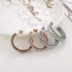 Gold and silver C-shaped hoop earrings with rectangular cubic zirconia inlay