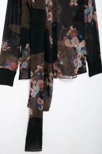 Detail of floral chiffon shirt showing semi-transparent fabric and vintage necktie design