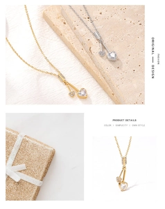 Detailed view of heart-shaped pendants in gold and silver with zircon stone settings
