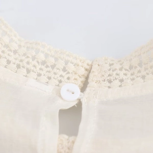 Elegant beige lace collar blouse featuring delicate floral embroidery and back button detail