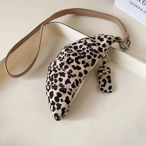 Detail of leopard print croissant coin purse necklace with brown faux leather strap
