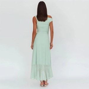 Detail of light green one-shoulder dress with elegant pleats and asymmetrical hemline