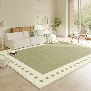 Waterproof cream style living room rug in grass green with geometric border detail