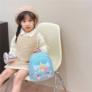 Toddler light blue unicorn backpack with colorful sequins shown by a child model