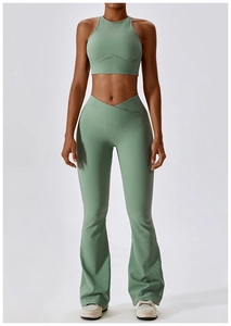 Detail of ribbed gray-green yoga set featuring a cross V-waist flared pants and crop top