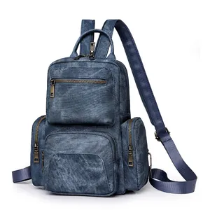 Vintage blue denim multi-zipper backpack with adjustable straps and bronze metal hardware