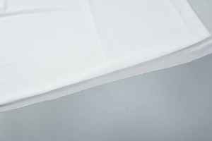 Detail view of lightweight white mesh fabric with subtle pleats and double lining