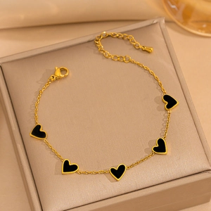 18K gold plated stainless steel bracelet featuring five black enamel heart charms