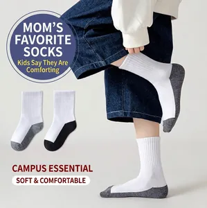 Detail of white mid-calf school socks with reinforced grey heels and toes for children