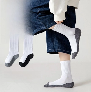 Detail of white mid-calf school socks with reinforced grey heels and toes for children