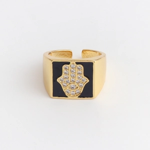 Detailed view of gold Hamsa Hand ring with black enamel inlay and cubic zirconia stones