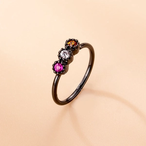 Detail of black micro-pave nose ring with rose red, clear, and orange zircon stones