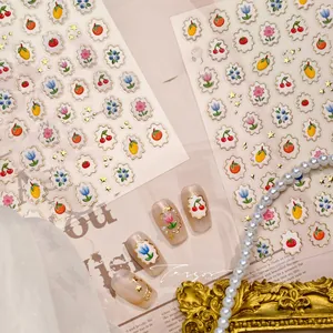 Detail of 3D embossed nail stickers featuring vintage fruit and gold tulip patterns