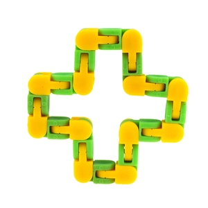 Detail of green and yellow plastic wacky tracks fidget toy folded in a cross shape