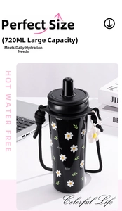 Close-up of 720ml black insulated cup with daisy patterns and woven lanyard strap
