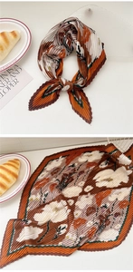 Detail of pleated silk scarf with vintage floral print and micro-organ pleat texture