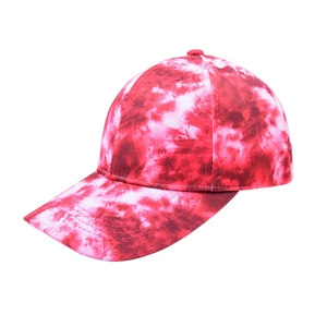 Detailed view of tie-dye baseball cap with red and white patterns and curved brim