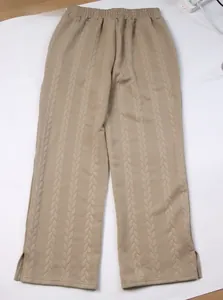 Macro detail of beige cable knit pants with ribbed elastic waist and side split hem