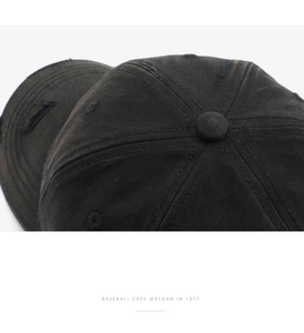 Macro close-up of distressed cotton baseball cap showing ripped details and vintage texture