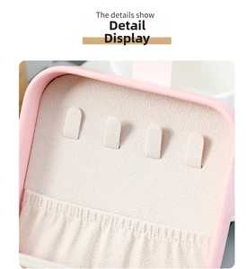 Pink PU leather jewelry box detail with four necklace hooks and an elastic storage pocket