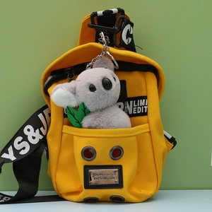 Yellow canvas crossbody bag featuring a cute grey koala plush keychain accessory