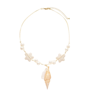 Resort style pearl necklace featuring conch and starfish pendants with a chic beach vibe