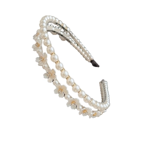 Elegant double-layered headband with white pearls and small floral charms on white background