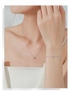 Detail of pink morganite necklace and bracelet set on model with silver-tone chain