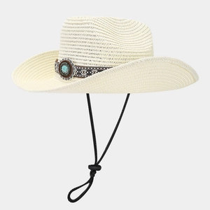 Detail of straw cowboy hat with ethnic decorative band and turquoise metal buckle