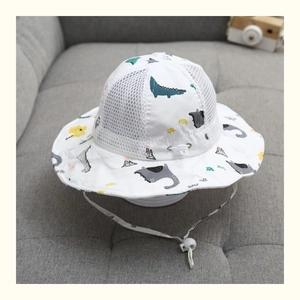 Dettaglio del cappello da sole per neonati traspirante con motivi di dinosauri