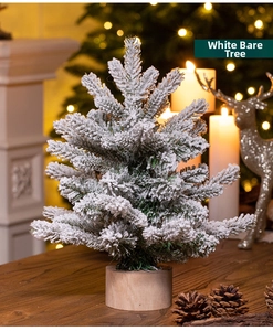 Close-up of a flocked mini Christmas tree with artificial snow and a natural wood base
