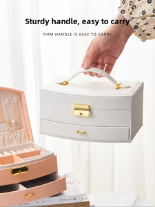 Detail view of the firm carry handle on this white multi-layer jewelry organizer box