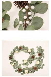 Close-up of white pumpkins, pine cones, and eucalyptus leaves on a Christmas wreath