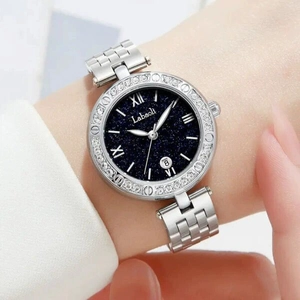 Women's silver steel watch with starry blue dial and rhinestone bezel on wrist