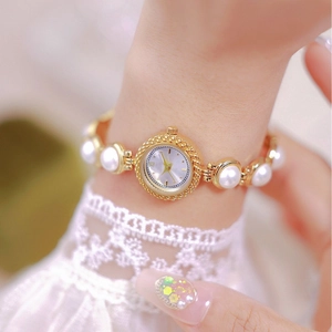 Elegant gold quartz watch for women featuring a pearl bead bracelet and round dial