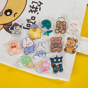 Set of cute cartoon animal acrylic pins featuring bear and rabbit on a white canvas bag
