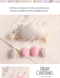 Cloud felt hanging ornament with pink raindrops and LED fairy lights on vintage paper