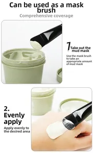 Detail of applying white facial mud mask using a flat black handle soft bristle brush
