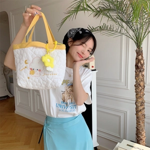 Quilted white heart-pattern tote bag with yellow straps and cute floral charm