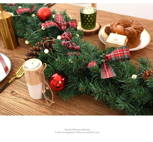 Close-up of 2.7m Christmas garland with plaid bows, pine cones and red berry details