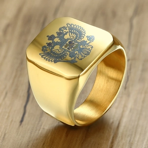 Macro detail of men's gold stainless steel signet ring with engraved double-headed eagle