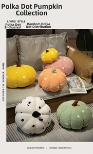 Close-up of colorful polka dot pumpkin plush cushions in various soft textile colors