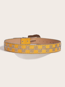 Detail of yellow punk belt with silver metal studs and embossed faux crocodile texture