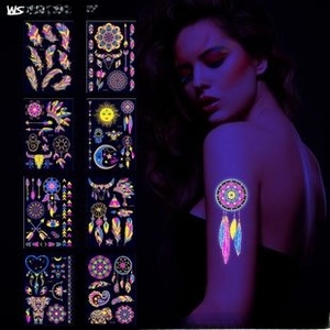 Luminous tattoo set with dreamcatcher and feather patterns glowing under UV light