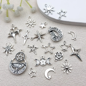 Detailed view of silver sun, moon and star alloy pendants for DIY jewelry making