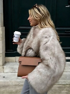 Chic street style look featuring a grey faux fur coat with a brown leather handbag