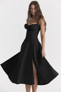 Detail of elegant black slip dress with drawstring bustier and side high slit design